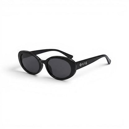 EVIE EYEWEAR black oval sunglasses with glossy finish and dark UV-protective lenses. Minimalist design with engraved logo.
