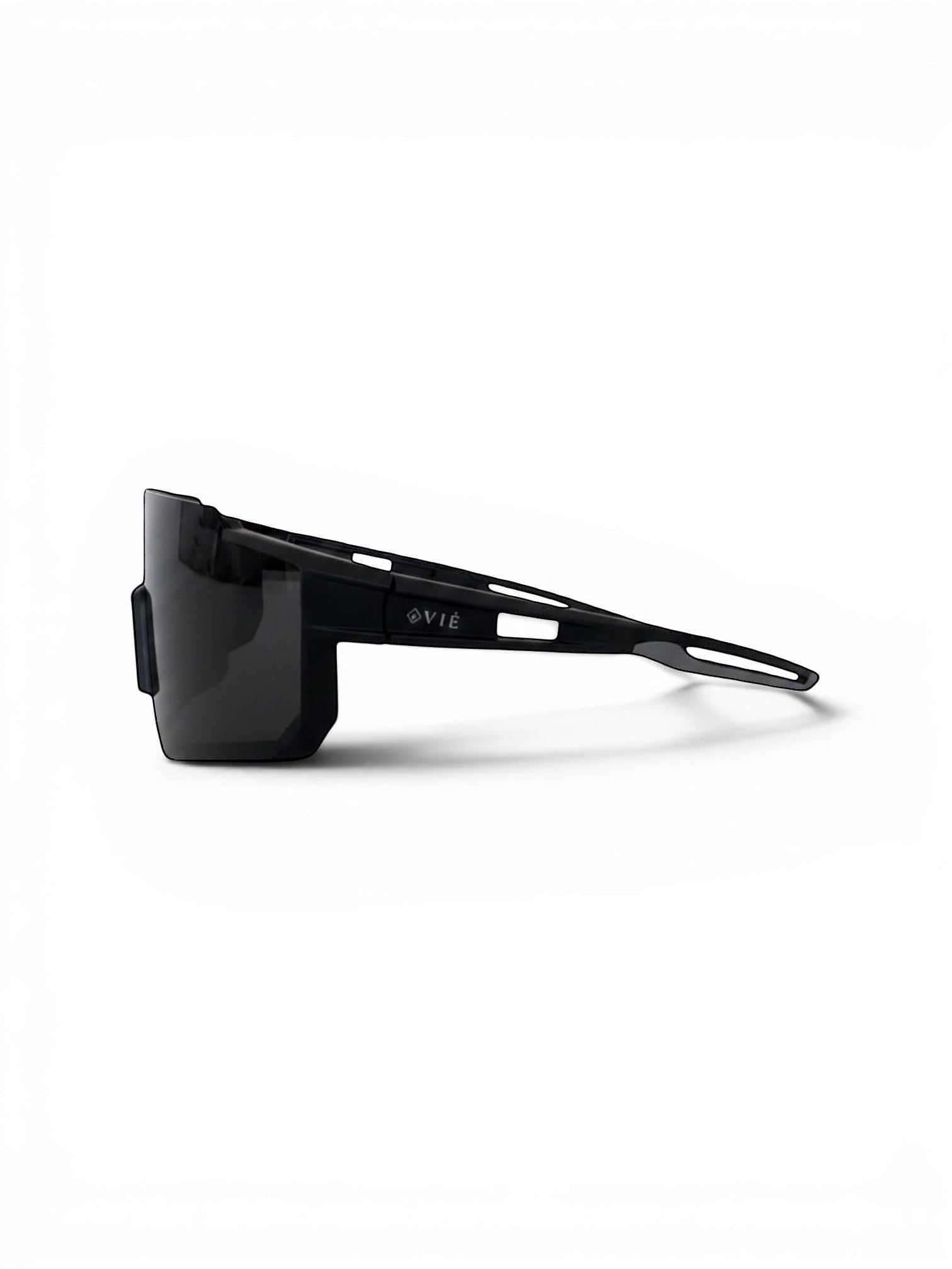 EVIE EYEWEAR black sport sunglasses with a wraparound design and grey accents on the temples, resting on a grey textured surface.